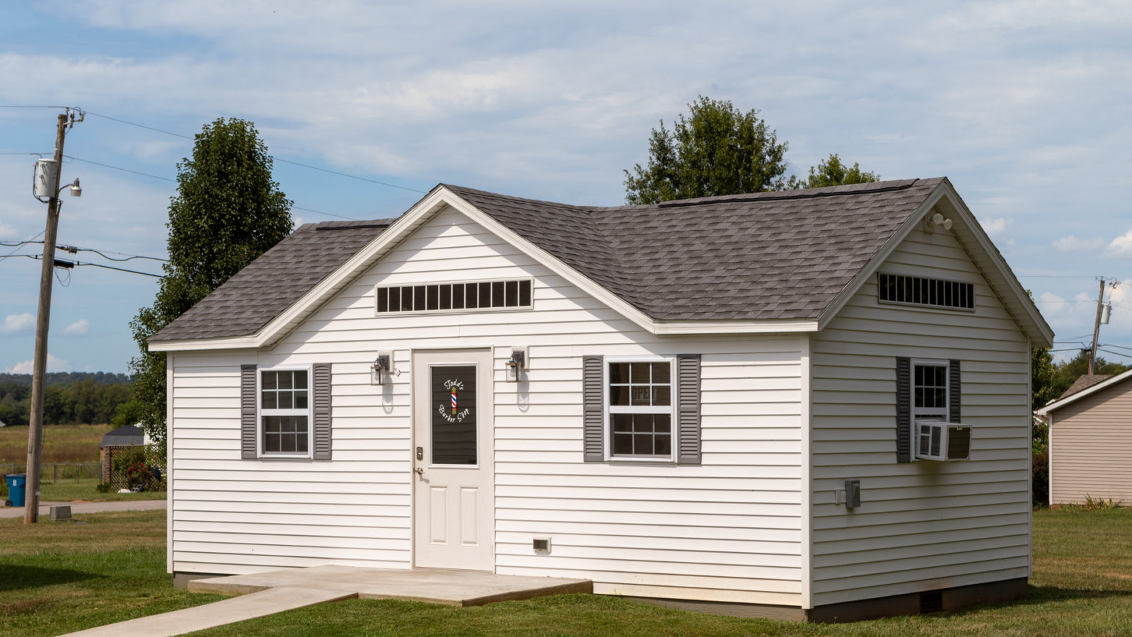 exterior of white barbershop backyard shed for sale in KY and TN