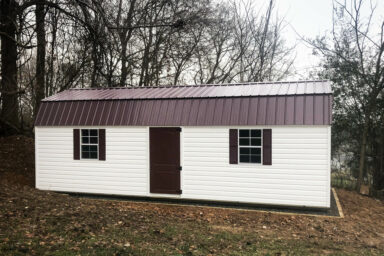 White vinyl shed with a metal roof in Kentucky.