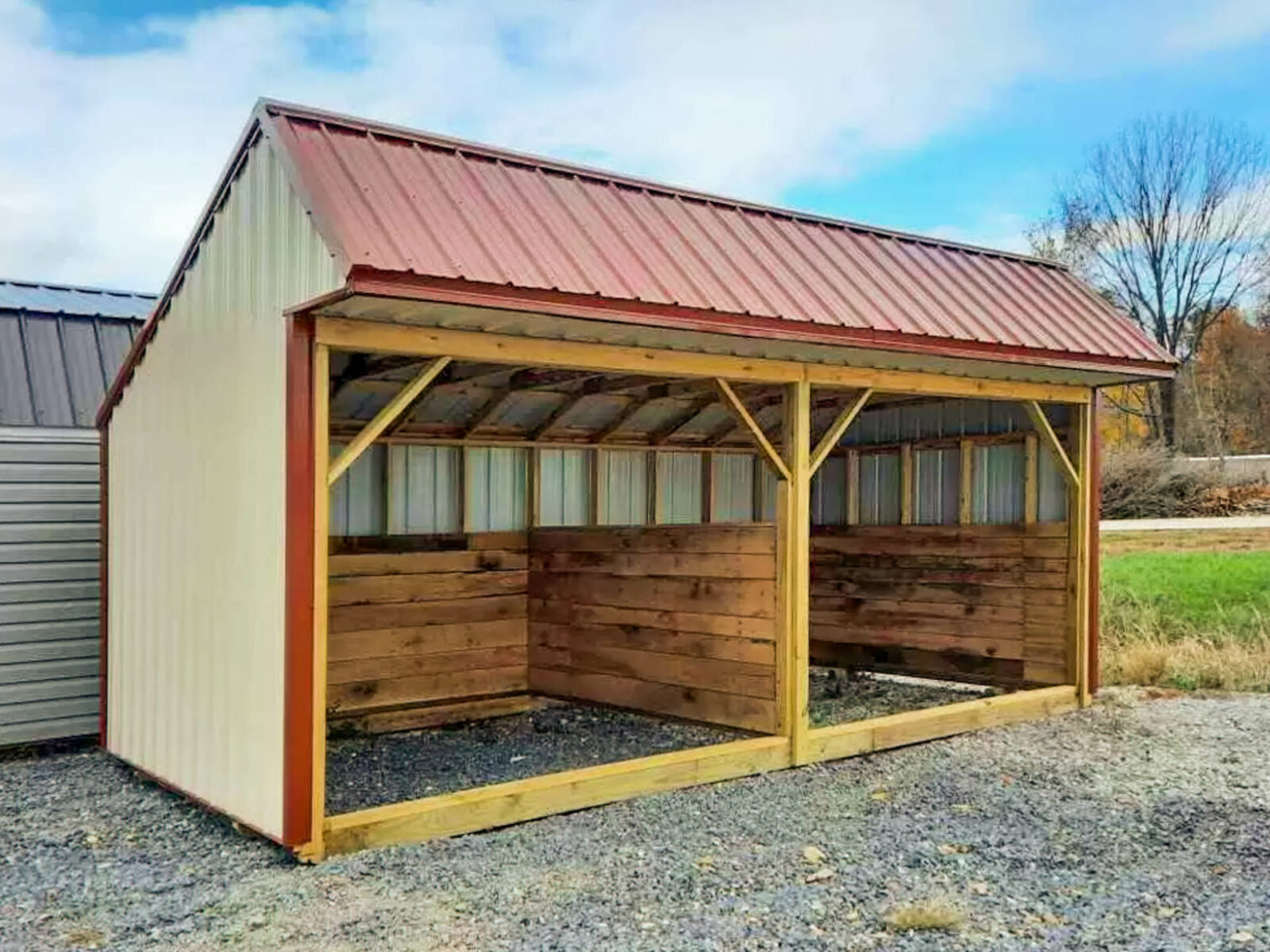 A small horse barn with metal siding and roofing.