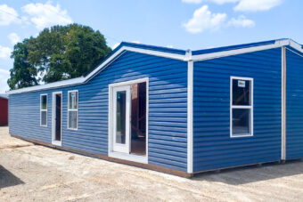 exterior of blue double wide tiny home shell
