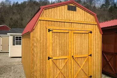 A portable building in Kentucky with wood siding and a metal roof