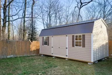 A portable building in Kentucky with vinyl siding and a metal roof