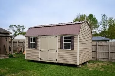 A portable building in Kentucky with vinyl siding and double doors