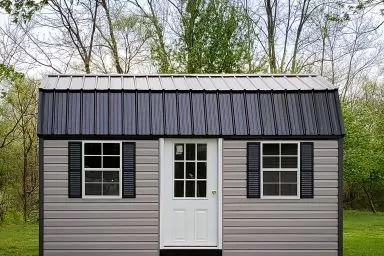 A portable building in Kentucky with vinyl siding and a black metal roof