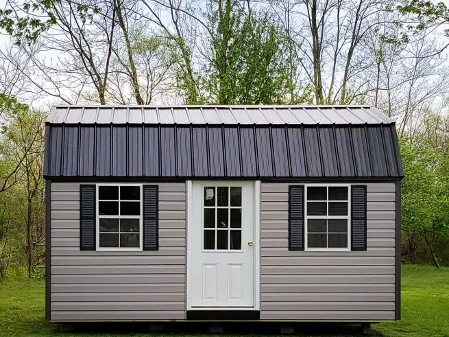 A portable building in Kentucky with vinyl siding and a black metal roof
