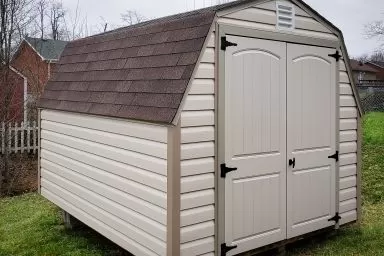 A portable building in Kentucky with vinyl siding and a shingle roof
