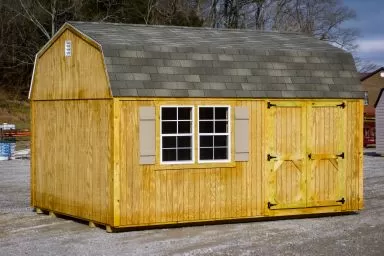 A shed in Kentucky with wooden siding and a shingle roof