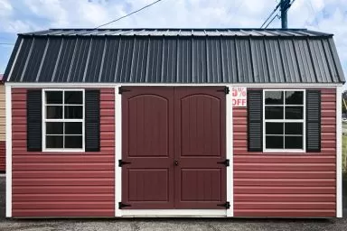 A red lofted shed in Kentucky with vinyl siding and a black metal roof