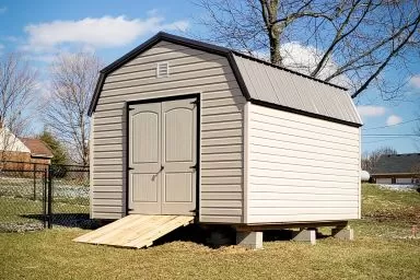 A lofted shed in Kentucky with vinyl siding and double doors