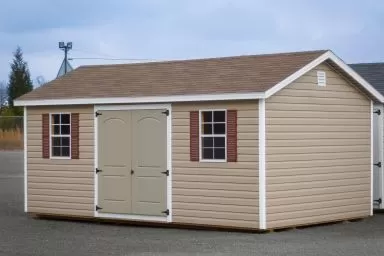 A shed in Kentucky with vinyl siding, windows, and a shingle roof