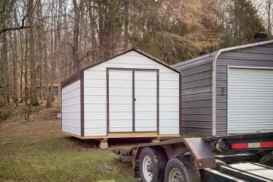 A vinyl shed with metal siding being delivered in Kentucky