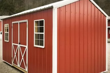 A metal shed in Kentucky with double doors and windows