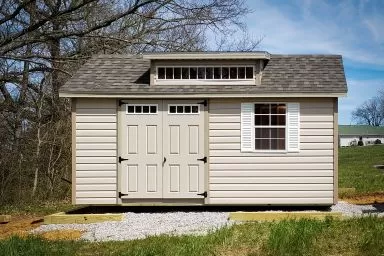 A vinyl shed in Kentucky with double doors, windows, and a roof dormer