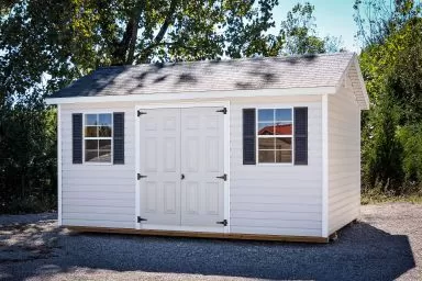 A white vinyl shed in Tennessee with double doors and a shingle roof