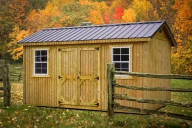 A shed in Tennessee with wooden siding and a metal roof