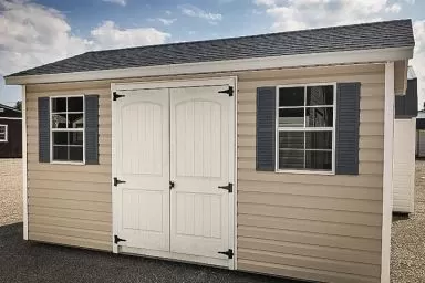 A shed in Tennessee with vinyl siding and a shingle roof