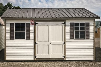 A discounted shed in Tennessee with white vinyl siding and a metal roof