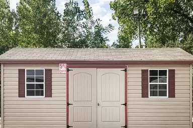 A discounted shed in Tennessee with vinyl siding and double doors