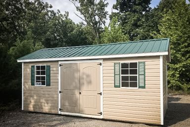 A shed in Tennessee with vinyl siding and a green metal roof