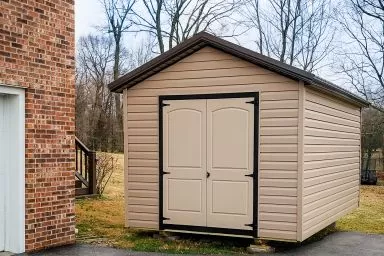 A delivered shed in Tennessee with vinyl siding and double doors