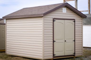 A storage shed in Kentucky with vinyl siding and double doors