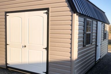 An outdoor shed in Kentucky with vinyl siding, two windows, and a black metal roof