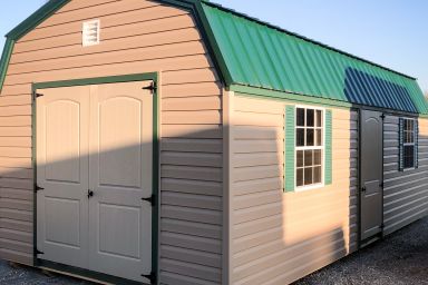 An outdoor shed in Kentucky with vinyl siding, two windows, and a green metal roof