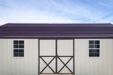 An outdoor shed in Kentucky with metal siding, two windows, and a metal roof