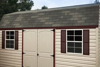 An outdoor shed in Tennessee with vinyl siding, double doors, and a shingle roof