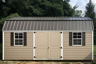 A lofted outdoor shed in Tennessee with vinyl siding, double doors, and a metal roof