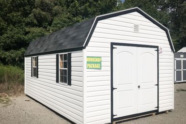 An outdoor shed workshop in Tennessee with vinyl siding, double doors, and a shingle roof