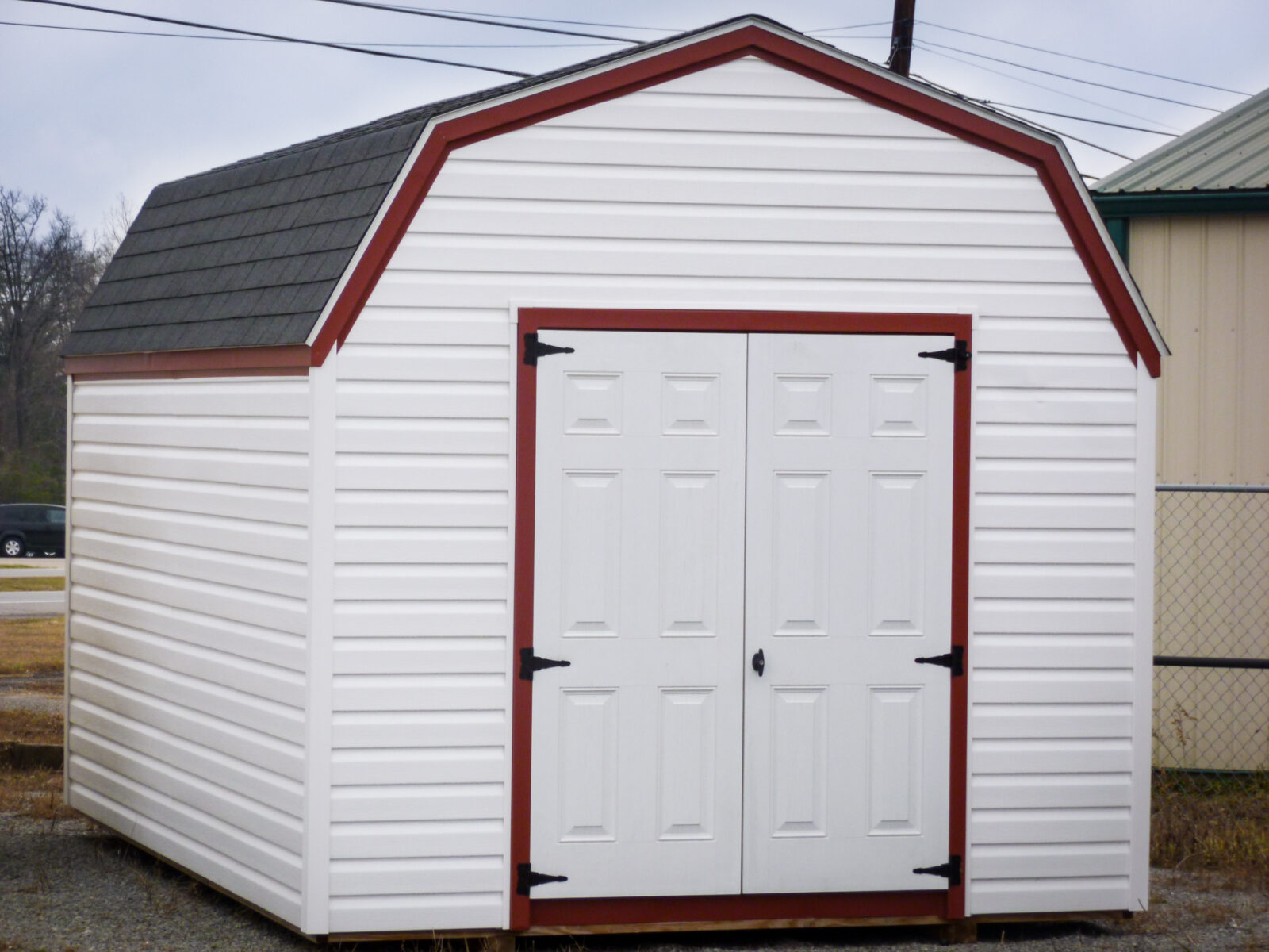 A storage building in Kentucky with vinyl siding and double doors