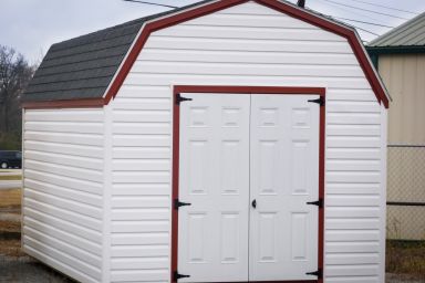 A storage building in Kentucky with vinyl siding and double doors
