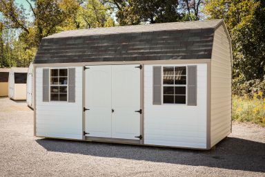 A prefab storage building in Kentucky with vinyl siding and double doors