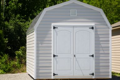A storage building with a loft in Kentucky with vinyl siding and double doors