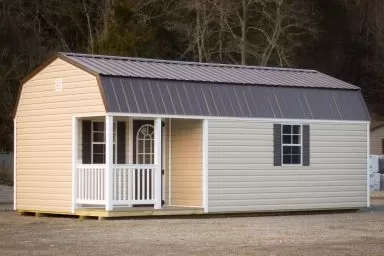 A small cabin for sale in Kentucky with vinyl siding and a loft