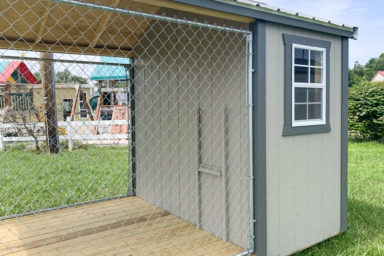 An outdoor dog kennel for sale in Tennessee with a chain link dog run