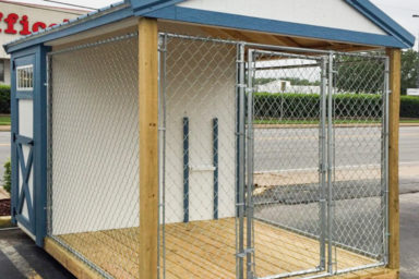 A prefab dog kennel for sale in Kentucky with wooden siding