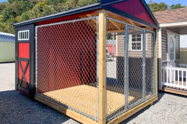 A red and black prefab dog kennel for sale in Tennessee with a metal roof