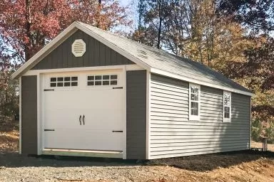 A portable garage in Tennessee with vinyl siding and a roof vent