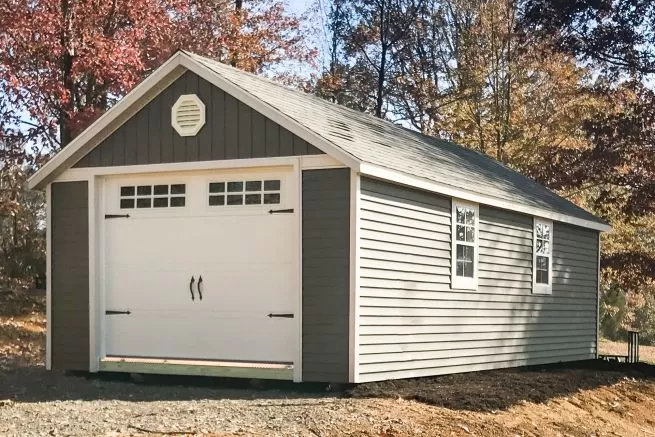 A portable garage in Tennessee with vinyl siding and a roof vent