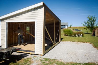 A modular garage with vinyl siding being delivered in Kentucky